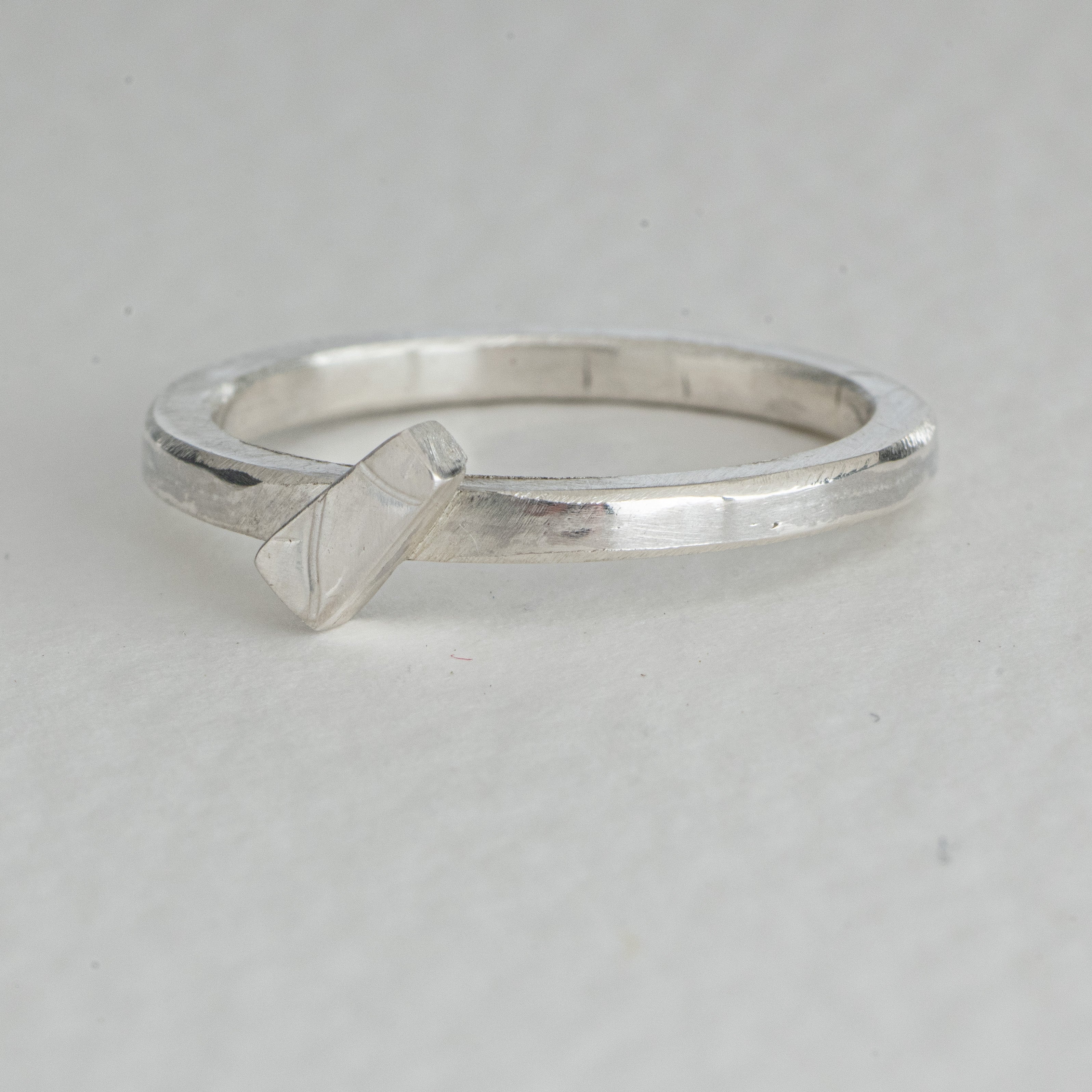 Plain band ring with embossed detail